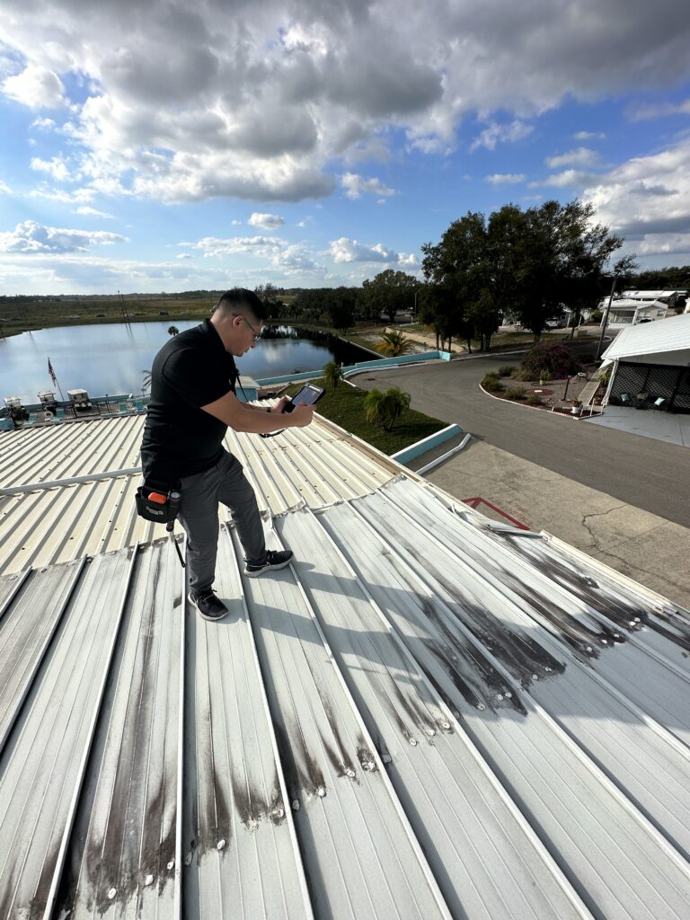 Public adjuster inspecting metal commercial roof for storm damage claims in Florida